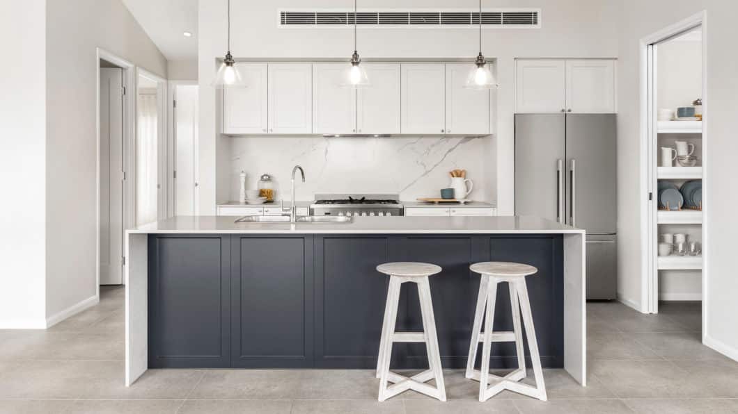 Hamptons kitchen with upper and lower cabinetry in the colour Ghostgum and the island in Battalion.