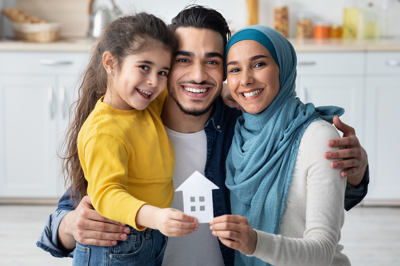 Family Housing. Happy Arabic Parents And Daughter Holding Ccutout Paper House Figure