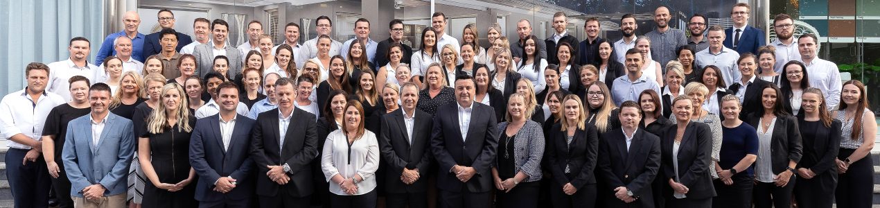Coral Homes Staff Group Shot Logo Edit Coral Homes Staff Group Shot Logo Edit